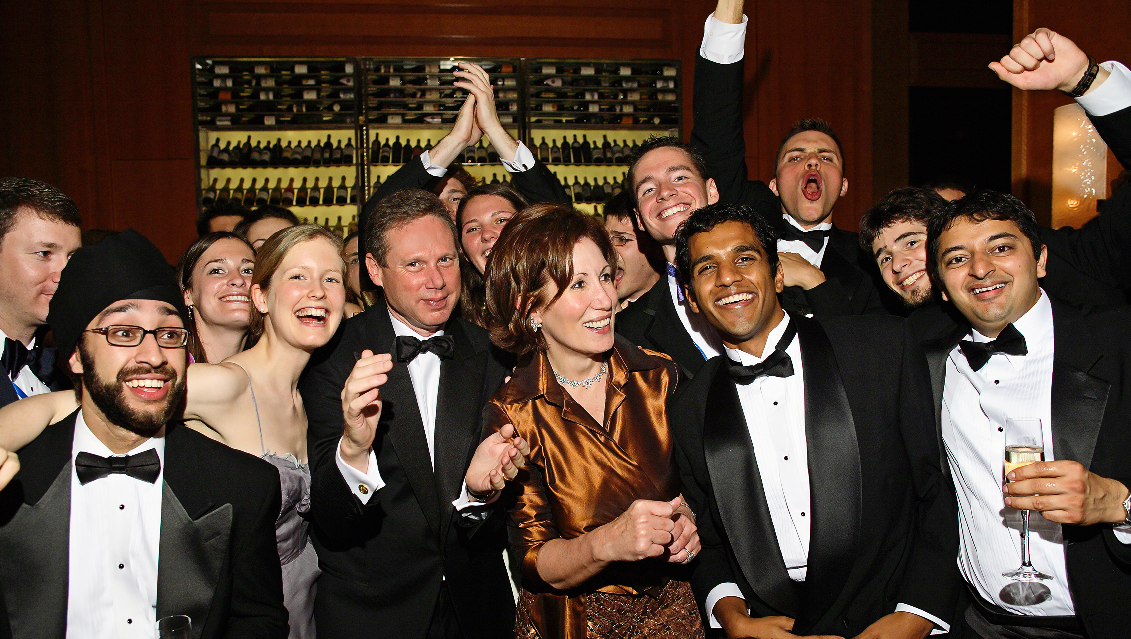 American Academy of Achievement Board Chairman Wayne Reynolds and Summit Host Chairman Catherine B. Reynolds enjoy Sheryl Crow's performance with enthusiastic student delegates at the 2006 Banquet ceremonies.
