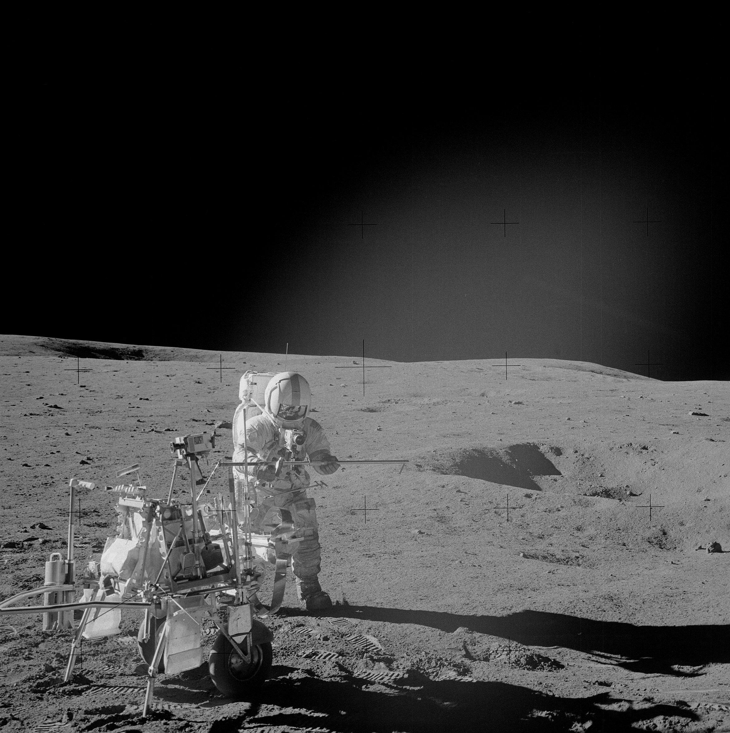 Mission commander Alan Shepard assembles a double core tube. Astronauts Shepard and lunar module pilot Edgar D. Mitchell, who took this photograph, explored the lunar surface while astronaut Stuart A. Roosa, command module pilot, orbited the moon. (NASA)