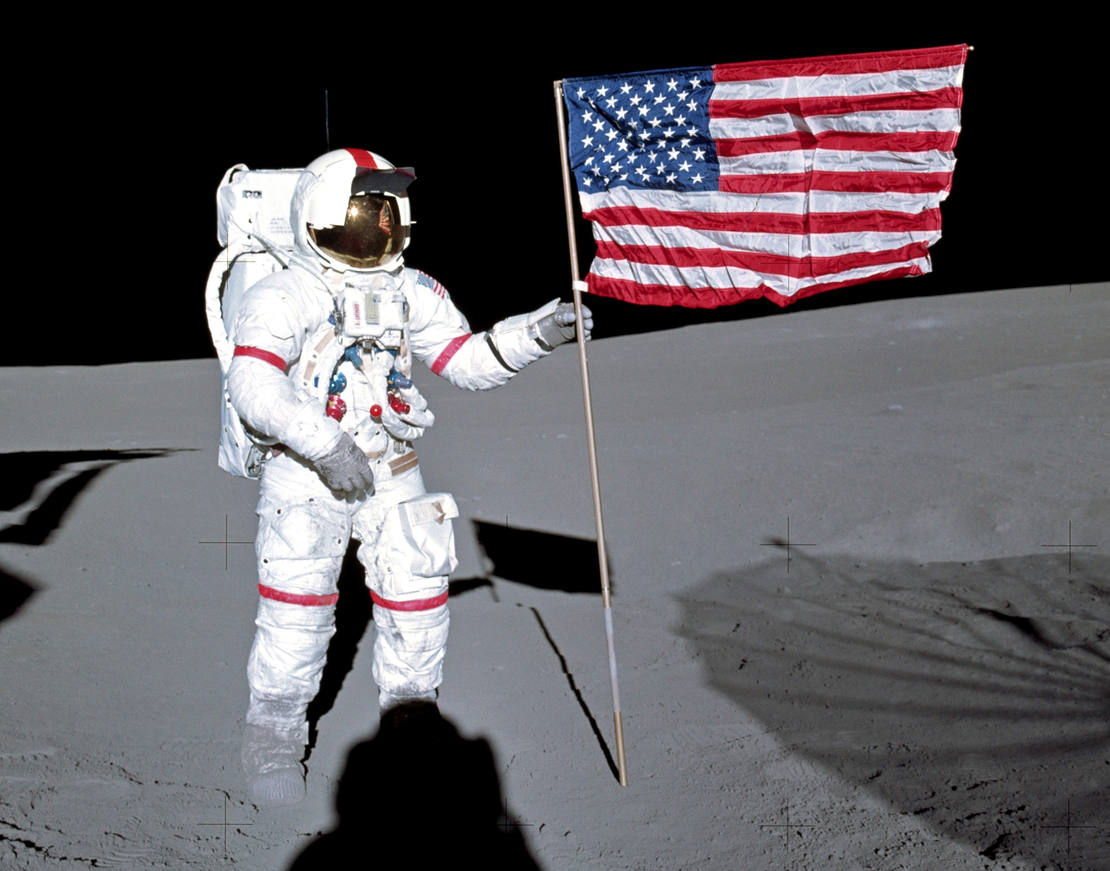 Alan Shepard plants the American flag on the moon.