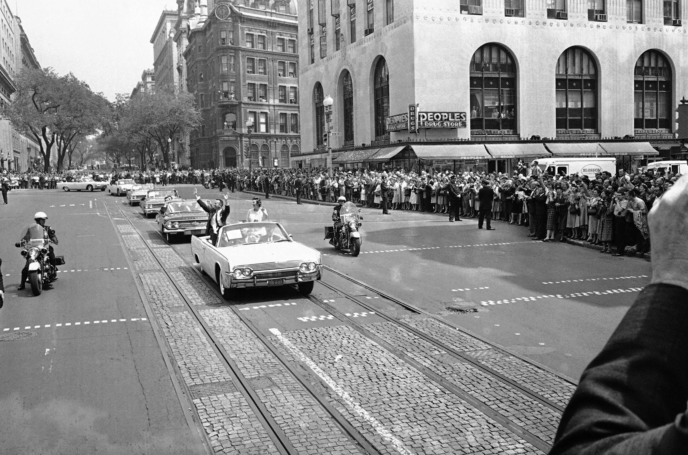 Astronaut Alan Shepard, the United States's first spaceman, waves to crowds lining 15th Street as he sits with his wife Louise in an open car during a parade from the White House to the U.S. Capitol Building in Washington on May 8, 1961. Other U.S. astronauts follow in the parade. (AP Photo)