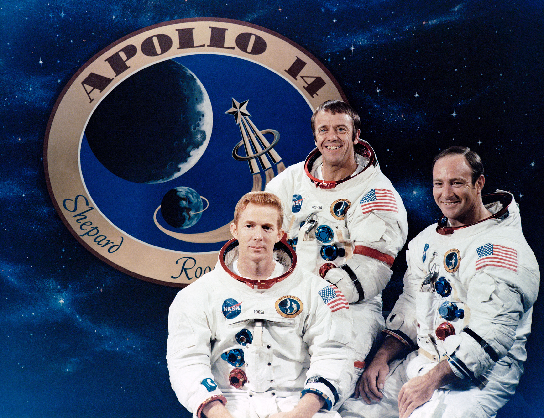 These three astronauts are the prime crew of the Apollo 14 lunar landing mission. They are Alan B. Shepard Jr., center, commander; Stuart A. Roosa, left, command module pilot; and Edgar D. Mitchell, lunar module pilot. The Apollo 14 emblem is in the background. (NASA)