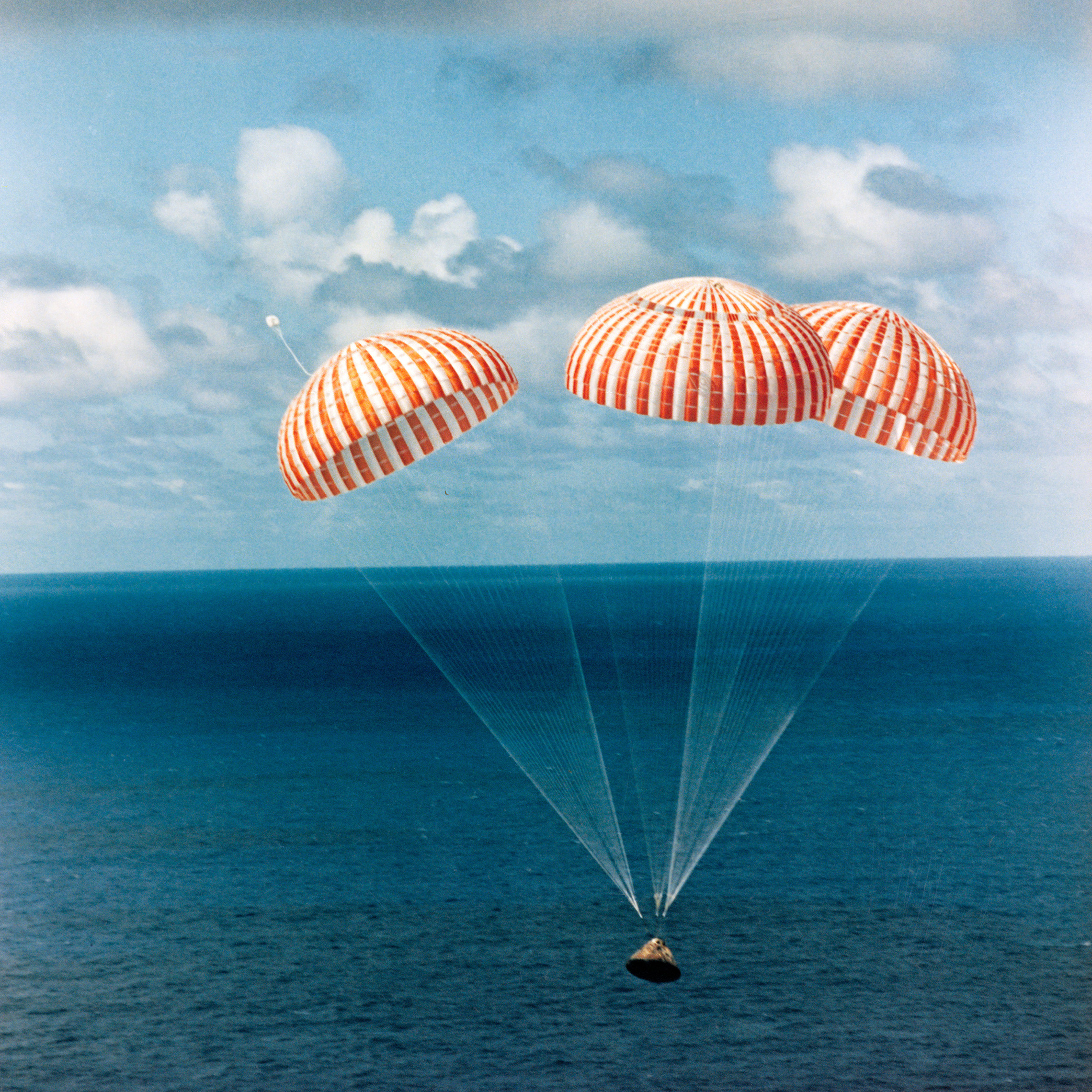 The Apollo 14 command module with astronauts Alan Shepard, Stuart A. Roosa and Edgar Mitchell aboard approaches touchdown in the South Pacific Ocean, bringing to successful end a 10-day lunar landing mission. The splashdown occurred at 3:04 CST, February 9, 1971, approximately 765 nautical miles south of American Samoa. The crew was flown by helicopter to the U.S.S. New Orleans prime recovery ship. (NASA)